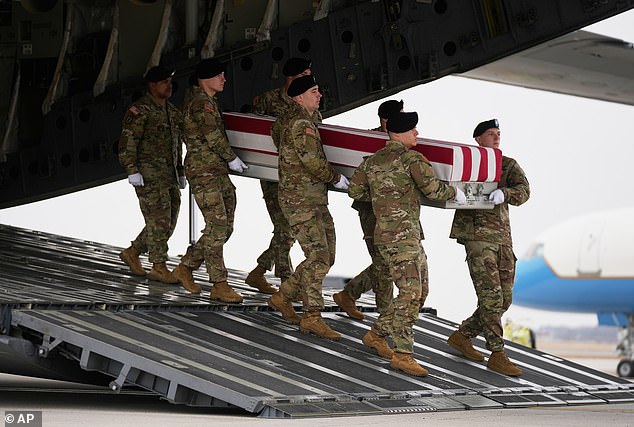 An Army team carries the remains of Sgt. Declan Coady, 20, who was killed in Kuwait by Iranian strikes early in the US-Iran war