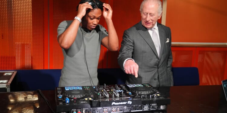 Moment King Charles, 77, has a go at DJing