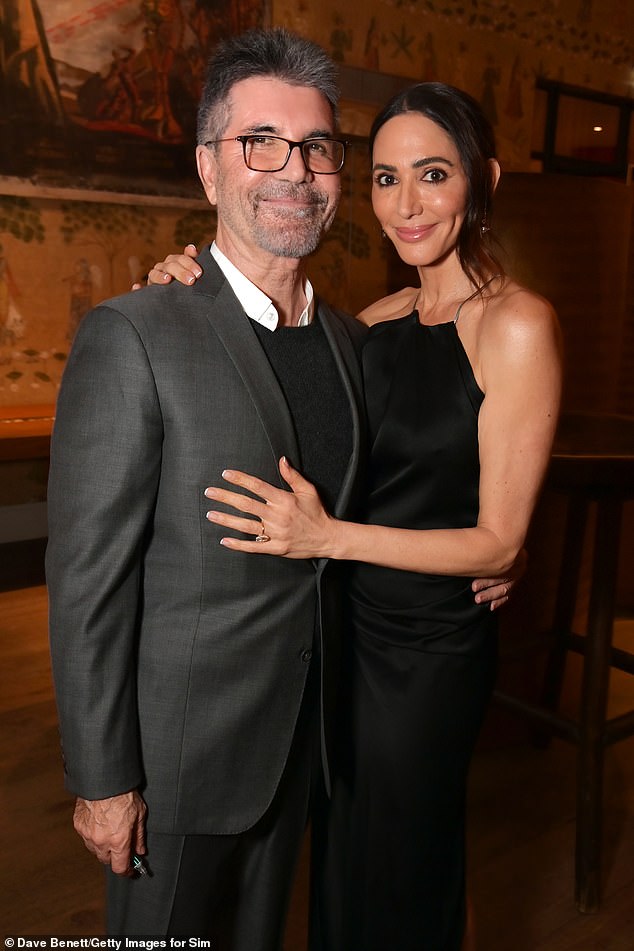 She wrote: 'For a long time Simon and I were very firm about one thing, no phone for Eric. (Simon himself hasn’t had a phone for nearly 8 years!)' (pictured together in December)