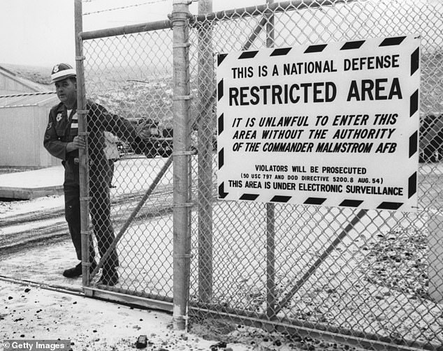 A guard closing the gate to entrance of the control center of the missile base at Malmstrom, Montana, where the ballistic missile 'Minuteman' were kept, in December 1962
