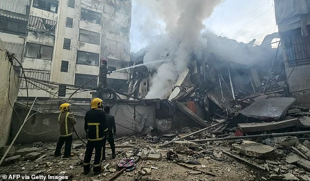 Firefighters extinguish a fire that swept through the site of an Israeli airstrike targeting Beirut's southern suburbs, in the al-Kafaat neighborhood, on March 17, 2026. Israel launched a wave of strikes on Tehran and Beirut on March 17, while attacks in Baghdad drew neighbouring Iraq deeper into the Middle East war that has sparked economic turmoil across the globe. (Photo by AFP via Getty Images)