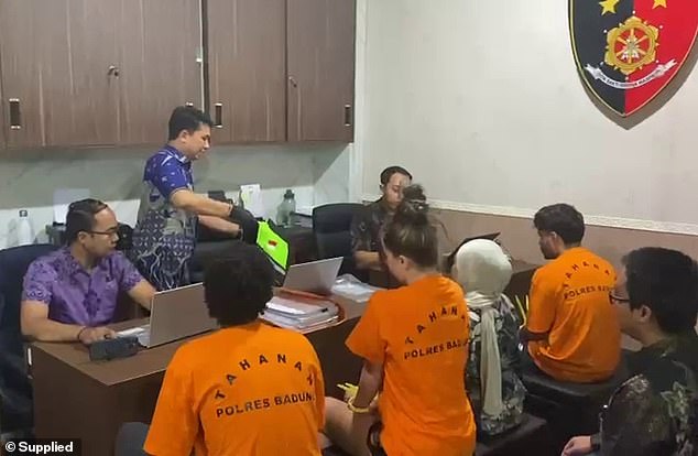 The woman, along with two other tourists (above), are accused of making pornography on the island