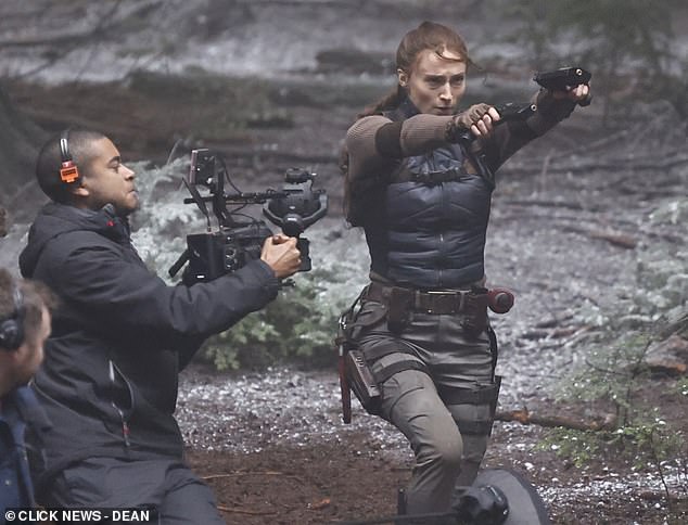 The actress, 29, who is the latest star to take on the iconic role, was seen swiftly moving through a woodland holding her two guns out as the crew filmed close-ups and a wide shot