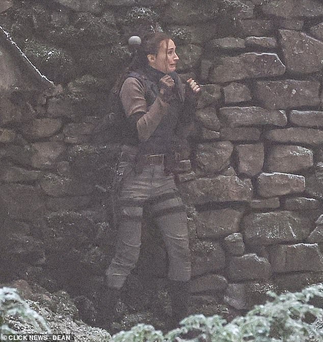 After throwing a weapon through the stone building window, it was thrown back at her causing Sophie to freeze