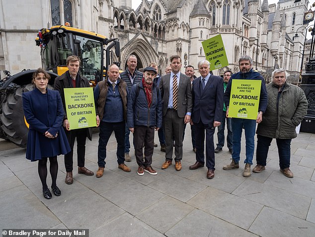 Protestors gather outside the Royal Courts of Justice