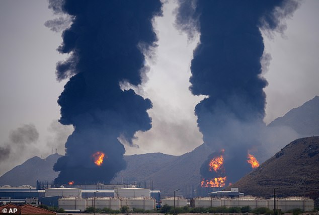 Plumes of smoke and fire rise after debris from an intercepted Iranian drone struck an oil facility, according to authorities, in Fujairah, United Arab Emirates, Saturday, March 14, 2026
