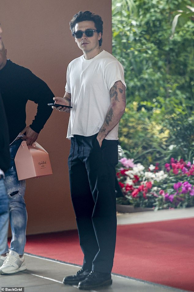 The Daily Mail can reveal that the former England captain had two very-near misses, with both father and son spending time at the hotel on Monday (Brooklyn pictured at the hotel in 2024)