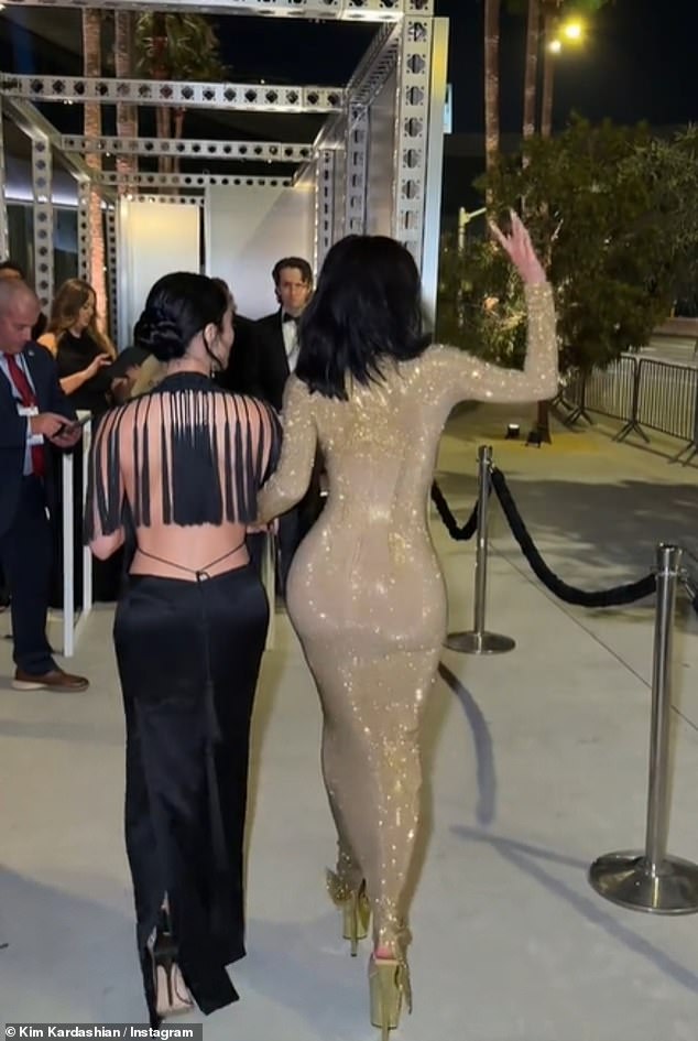 Before getting into her car, Kim asked her team to 'tighten' her huge heels and as she arrived she linked arms with Stephanie as they made their way onto the red carpet