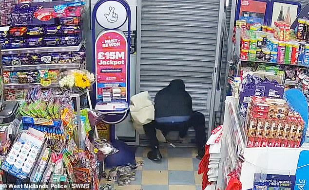 CCTV footage shows the employee swiftly flee and close the shutters behind him to trap the thief inside, who soon desperately tries to escape (pictured) - to no avail