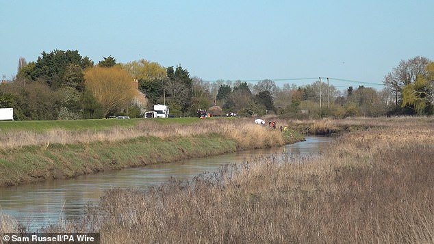 Police divers are scouring the water as one of the five people in the car - who were all between 16 and 18 - remains unaccounted for