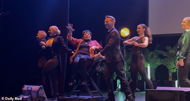 For the closing event, dancers carefully carried the Hollywood icon off stage while she waved at her fans