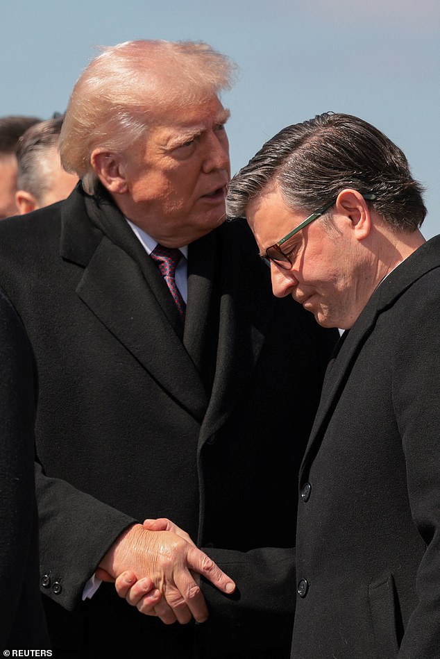 Trump shakes House Speaker Mike Johnson's hand as they arrive for the dignified transfer of six service members killed in a plane crash over Iraq airspace last week