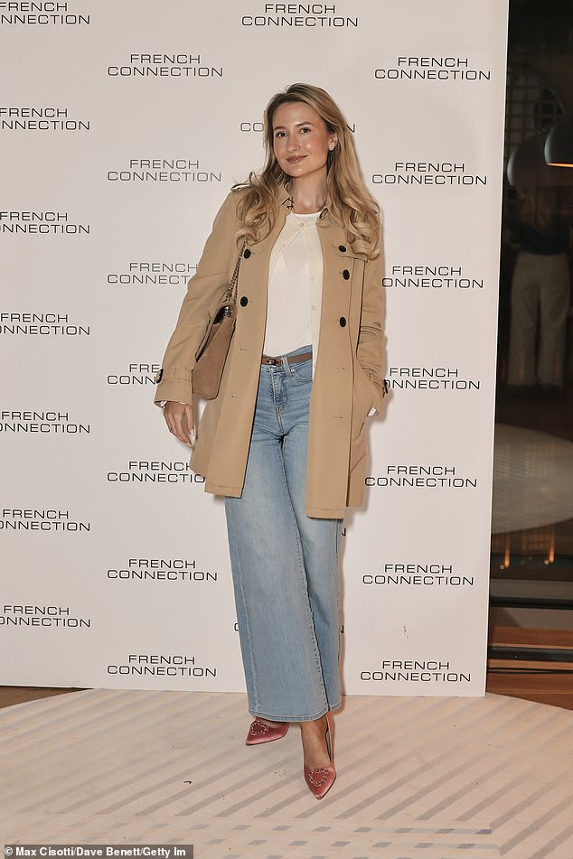 Social media star Scarlet Martin opted for a stylish nude trench coat as she arrived for the launch party