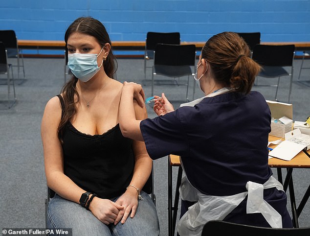 A student receives an injection in the sports hall at University of Kent on Wednesday