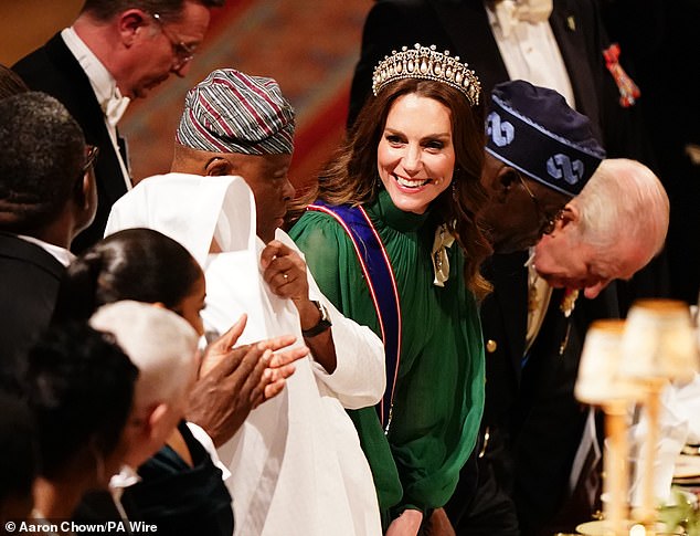 Princess Catherine broke into a winning smile as she took her seat next to the Nigerian president