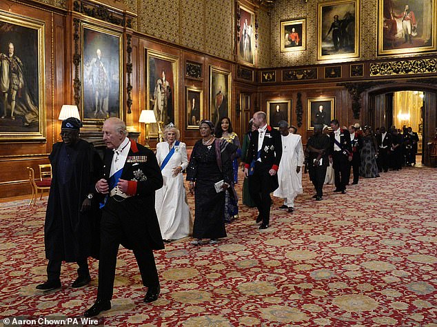 The King and the president lead the procession into St George's Hall for the banquet