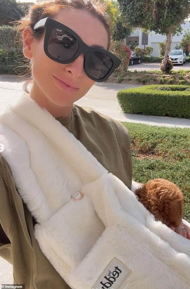 She shared a selfie showing her cradling the pup