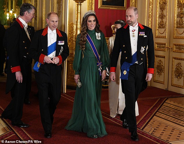 The Princess arrived at the banquet flanked by husband, the Prince of Wales, and The Duke of Edinburgh