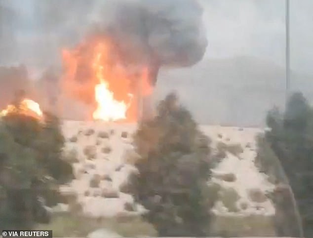 Smoke and flames rise from the South Pars gas field following an Israeli strike, as seen through the window of a moving vehicle. The strike represented a major escalation in the war and angered the US's European and Middle Eastern allies