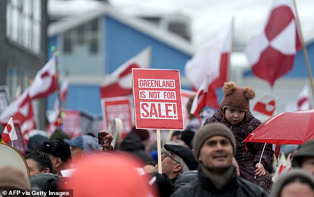Pictured: Protesters in Greenland demonstrate against Donald Trump's attempted takeover