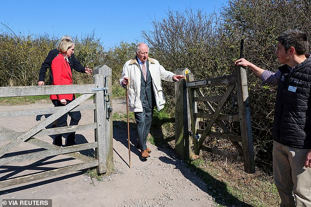 Britain's Secretary of State for Environment, Food and Rural Affairs Emma Reynolds and Britain's King Charles walk as he inaugurates 'The King Charles III England Coast Path' at Seven Sisters National Nature Reserve