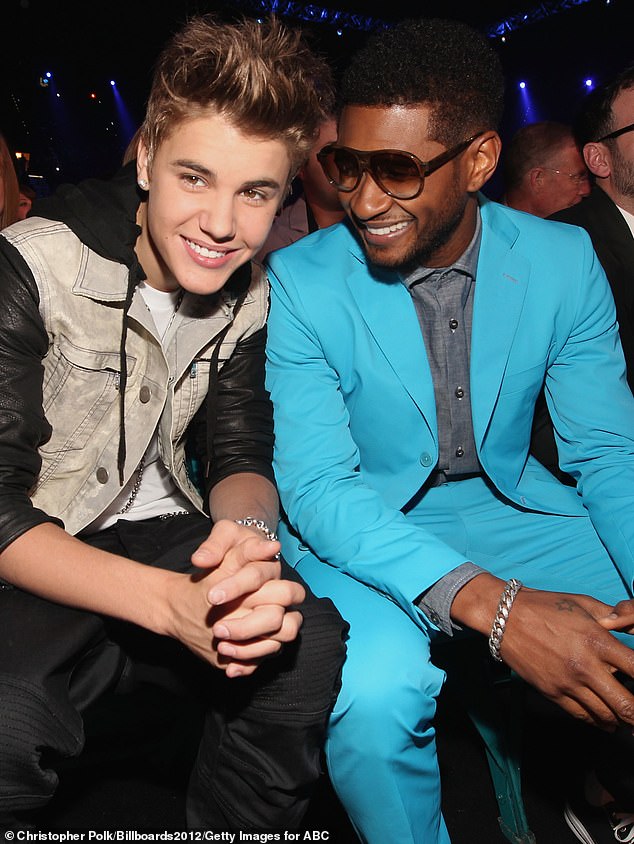 Bieber went viral for his singing videos on YouTube in 2007 at the age of 13, leading to his discovery by business partners Braun and Usher; Bieber and Usher pictured in 2012