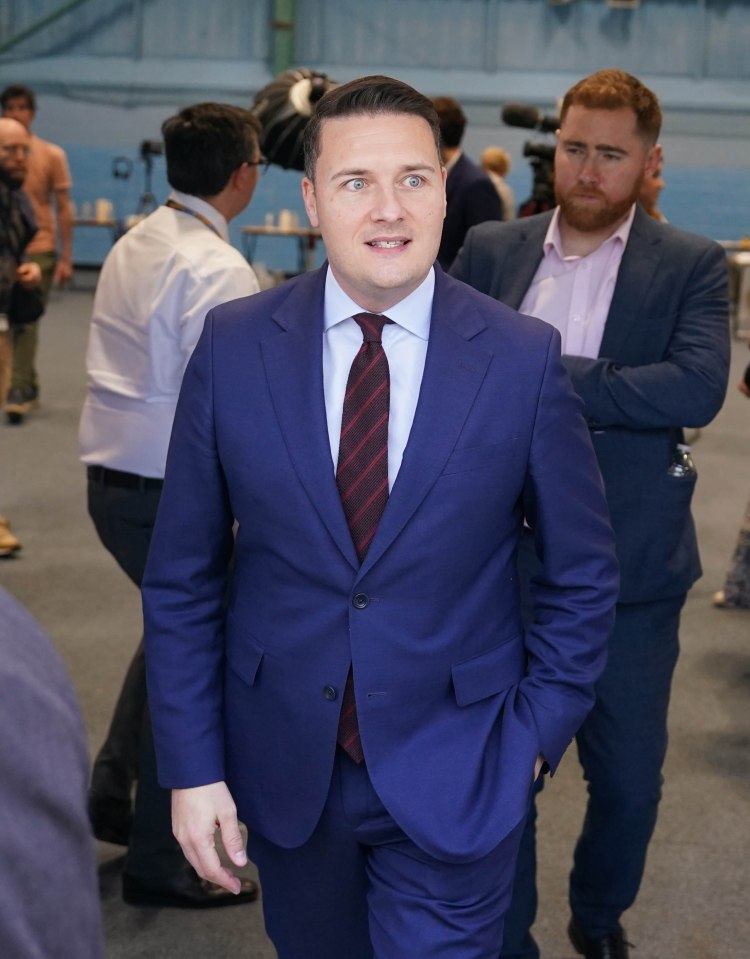 Wes Streeting, Secretary of State for Health and Social Care of the United Kingdom, in a blue suit, looking to the right.