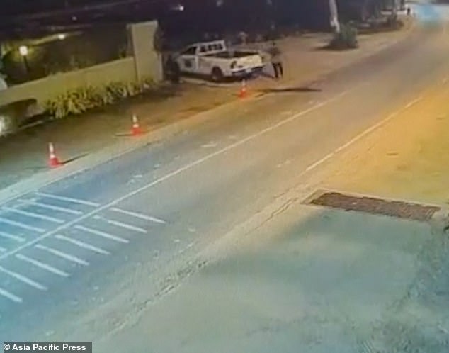 As he rounded the corner, Jordan grabbed onto a white Toyota pickup truck to steady himself