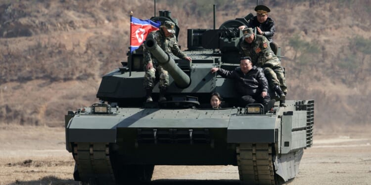 Grinning Kim Jong-un lets mini-me daughter drive TANK in matching leathers as he grooms teen to take on tyrannical reign