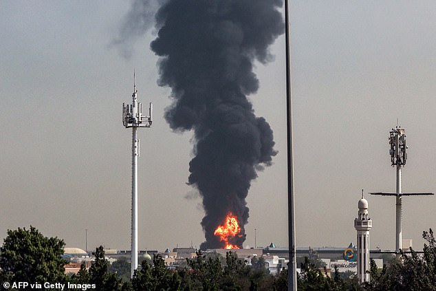 A smoke plume rises from a fire at Dubai International Airport in Dubai on March 16