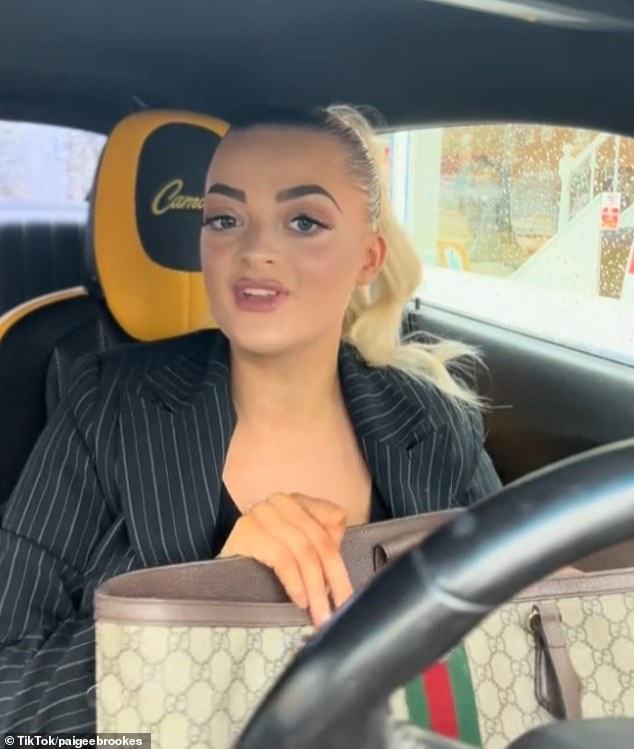 Blonde-haired Brookes poses from the seat of the Chevrolet Camaro at the centre of the case