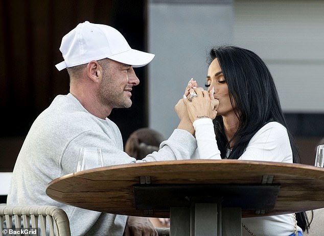 The couple shared a steamy smooch with the I'm A Celeb star lovingly caressing her husband's face and showing off her dazzling diamond wedding ring