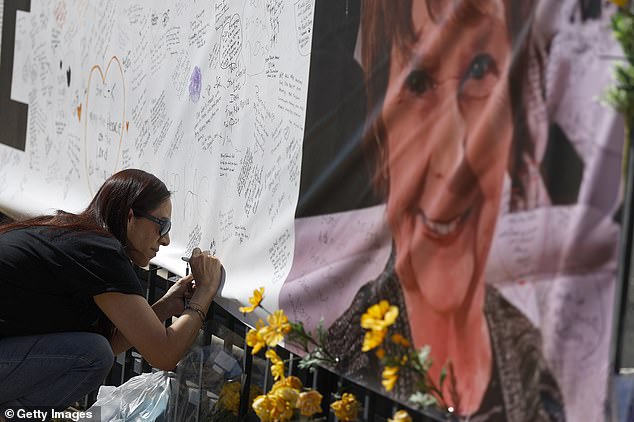 Catalina Ochoa visits a memorial for Nancy Guthrie in front of the KVOA news station