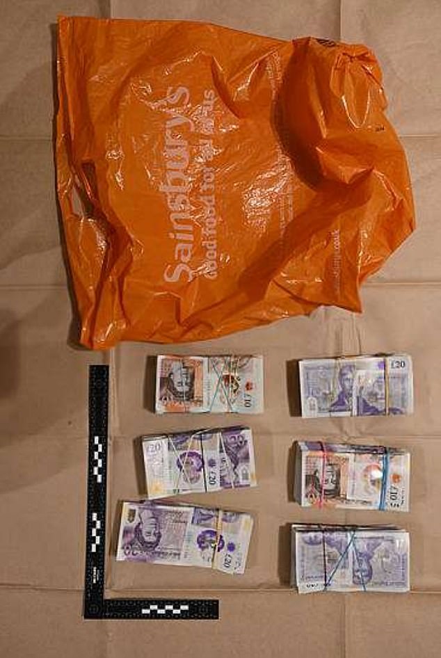 Police image shows wads of cash that were found in during the raid on the flat