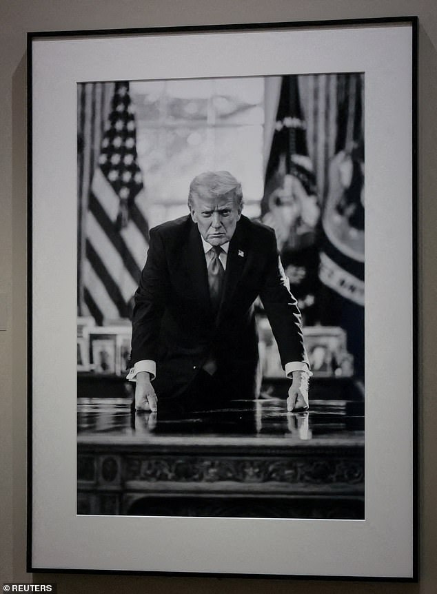 The design of the coin will portray a stern-looking Mr Trump leaning over his desk and looking ahead, based on a photograph displayed at the National Portrait Gallery in Washington