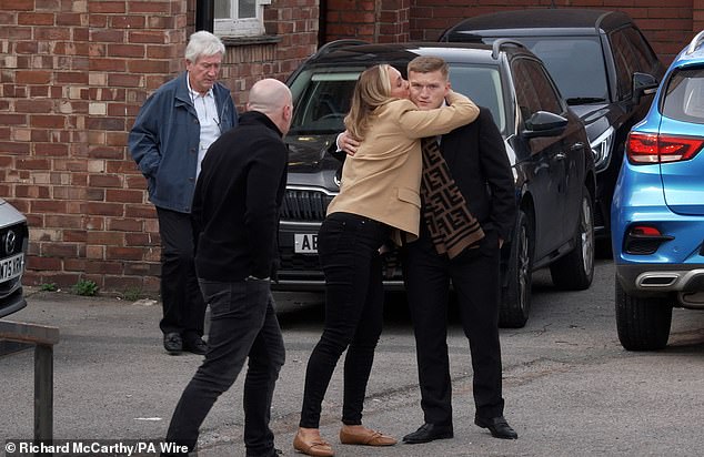 Matthew Hatton's partner Jenna Coyne kisses Hatton's son Cameron outside the court today