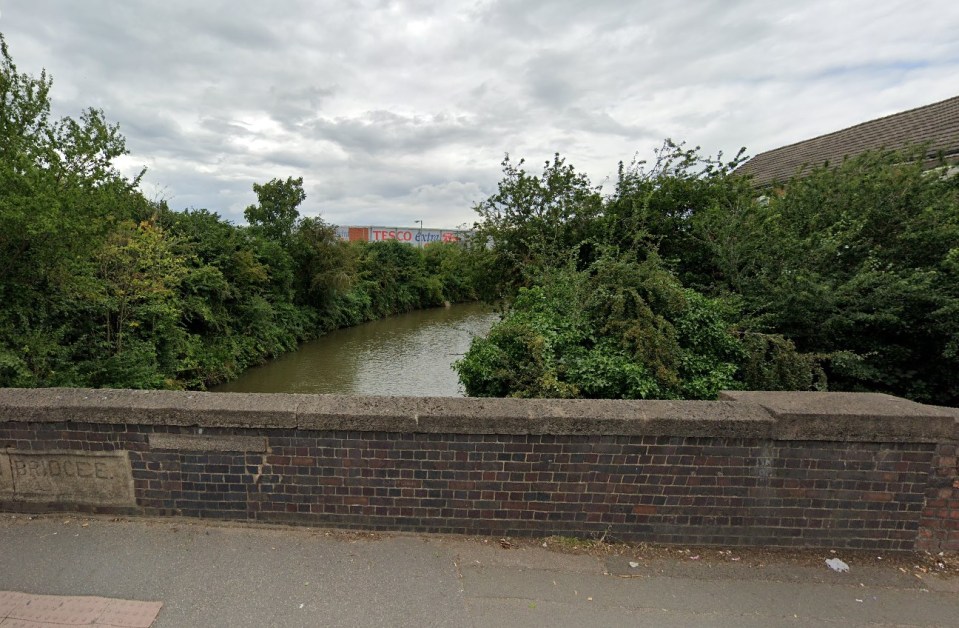 Rowley's Green Canal with a Tesco Extra sign visible in the background.
