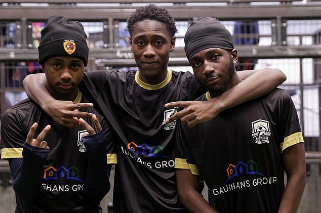 Junior pictured with two of his friends and teammates at the South London district football club