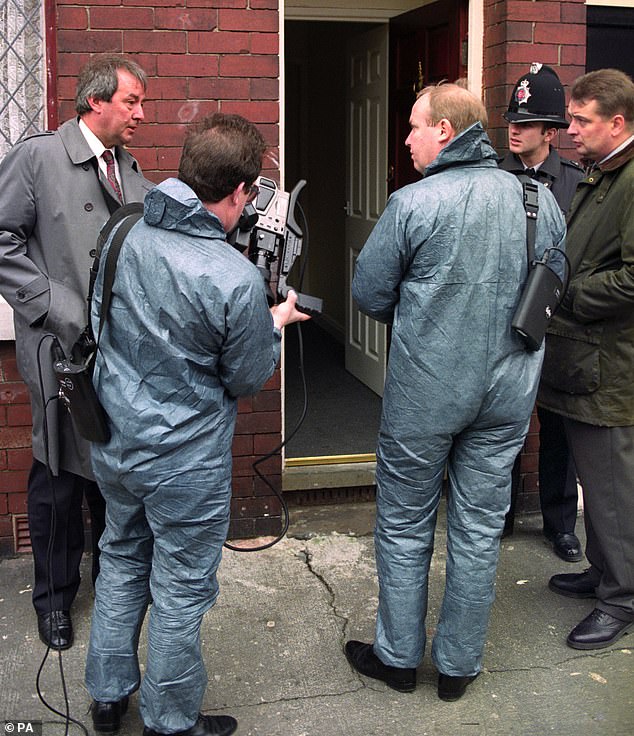 Pictured: Police officers search an address in Moston at the time of the kidnap and murder of Suzanne