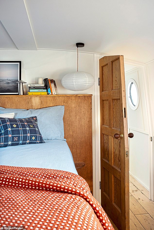 The main bedroom features a bespoke wooden headboard that Rosanna uses as a storage shelf