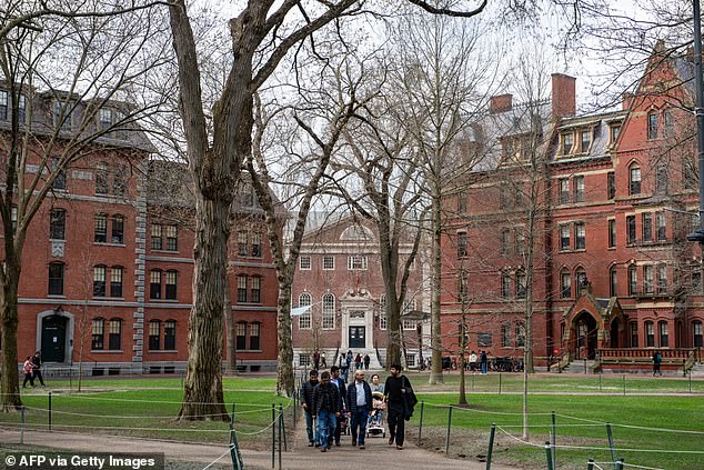 A file photo shows people walking through Harvard Yard on the campus in Cambridge, Massachussetts
