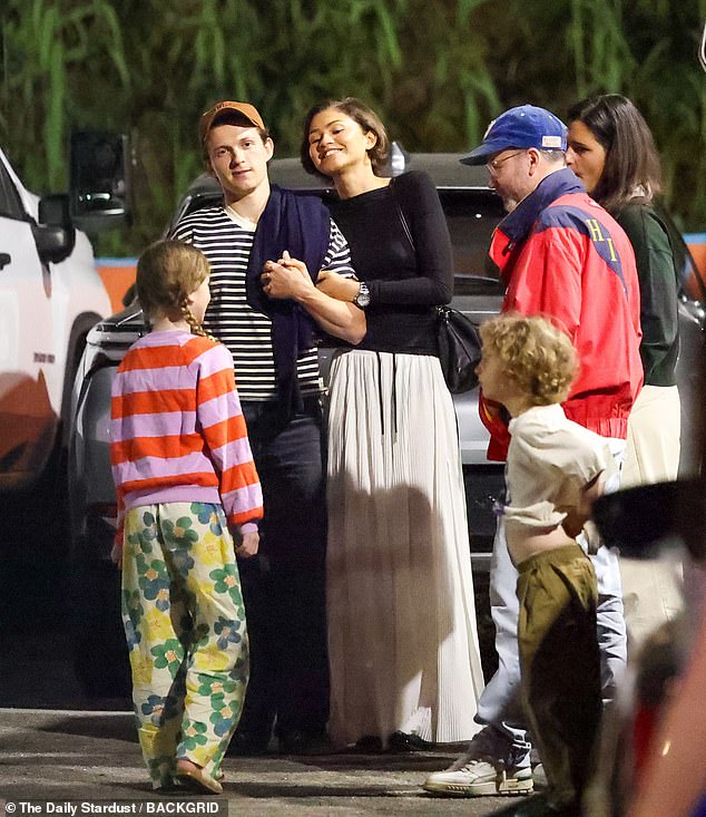 The pair seemed to be amused by something as they conversed with the children