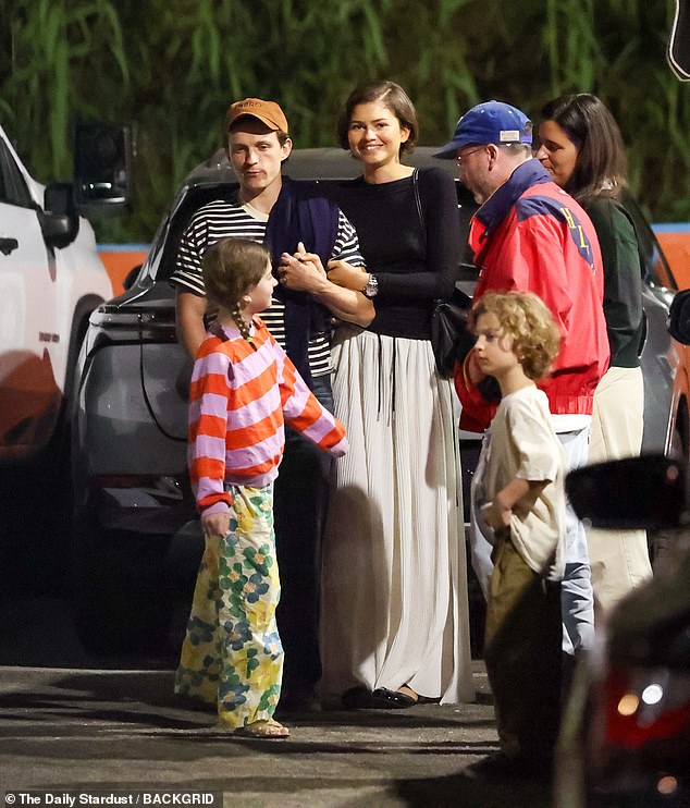 The Euphoria actress was beaming ear to ear as she clasped hands with Holland