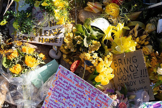Residents of Tucson have consistently left signs, messages of encouragement and flowers in front of Nancy Guthrie's home since her disappearance