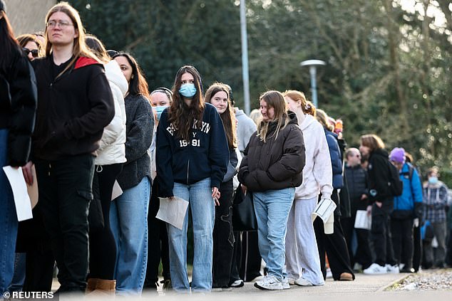 People, mainly students, queued this weekend to receive meningitis B vaccinations at a sports centre on the University of Kent campus