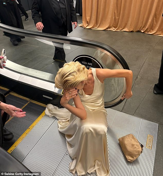 Getty could be seen sitting at the base of an escalator inside the Dolby Theatre where the awards ceremony had taken place
