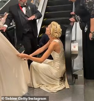 During a short clip included in the post, Getty was crouched down as she said, 'It's such a beautiful dress!'