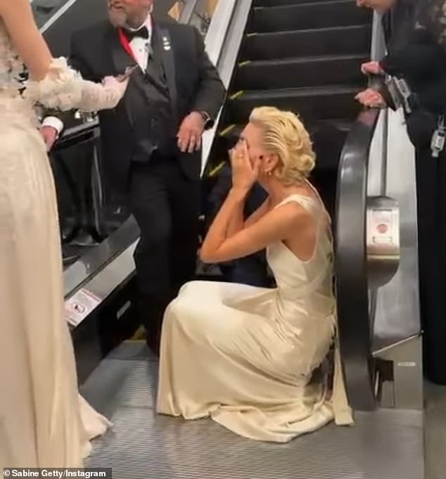 'No, it's really sad,' the designer said as staff continued to find a way to get the gown out