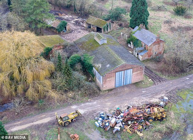 Pictured: Four of the five barns included in the conversion plans, along with a dilapidated cottage, far right, not included in the proposal