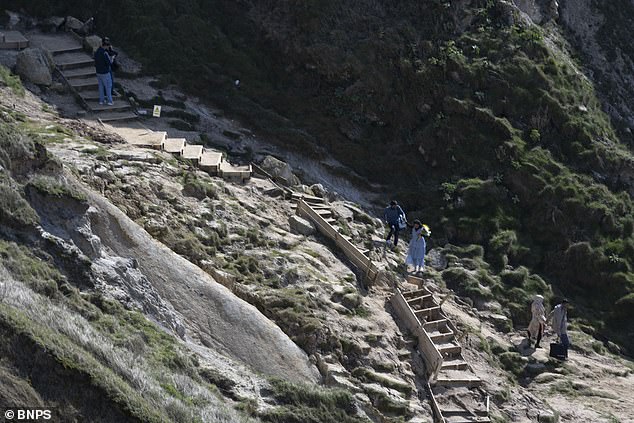 Visitors made their way down to the beach despite the red 'danger' signs having been installed at the site